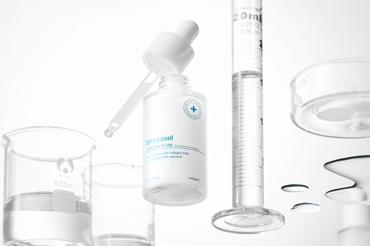 Shavik Spicuraxel Ampoule bottle with dropper, surrounded by laboratory glassware, highlighting the product's advanced formulation and scientific approach to skincare.